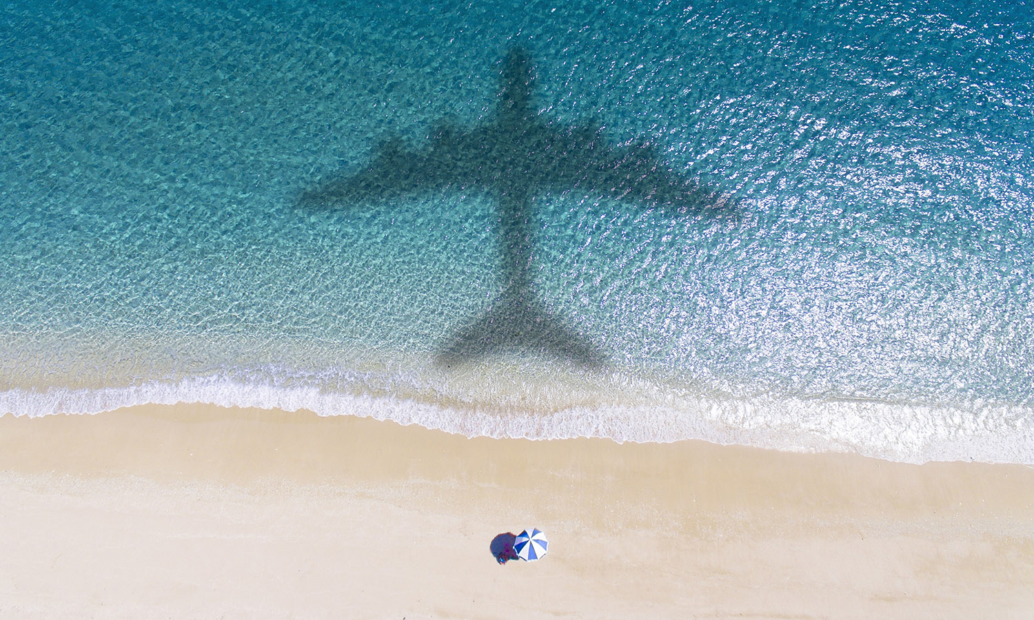 Plane flying over beach